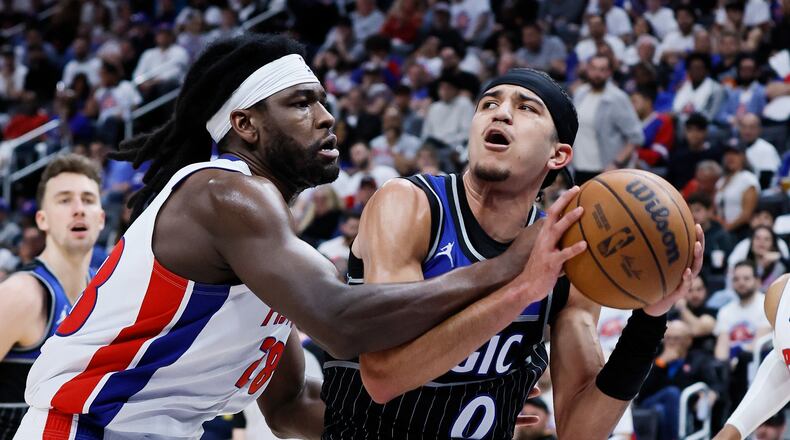 Orlando Magic guard Anthony Black (0) is fouled by Detroit Pistons forward Isaiah Stewart (28) while driving to the basket during the second half in Game 2 of a first-round NBA basketball playoffs series Wednesday, April 22, 2026, in Detroit. (AP Photo/Duane Burleson)