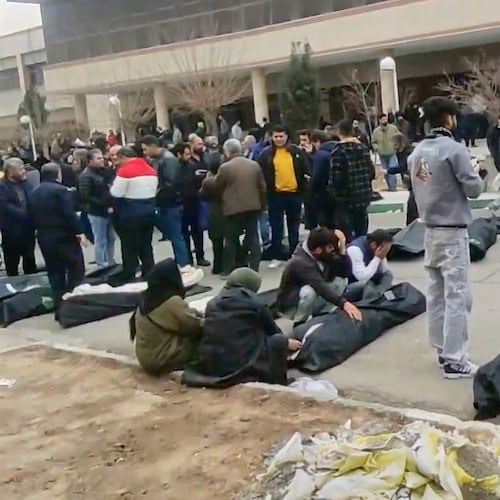 This frame grab from videos taken between Jan. 9 and Jan. 11, 2026, and circulating on social media purportedly shows images from a morgue with dozens of bodies and mourners after crackdown on the outskirts of Iran's capital, in Kahrizak, Tehran Province. (UGC via AP)
