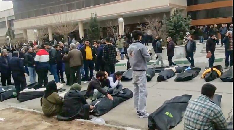 This frame grab from videos taken between Jan. 9 and Jan. 11, 2026, and circulating on social media purportedly shows images from a morgue with dozens of bodies and mourners after crackdown on the outskirts of Iran's capital, in Kahrizak, Tehran Province. (UGC via AP)