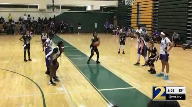 A screenshot of a video that allegedly shows the moments before a brawl broke out at a girls basketball game.