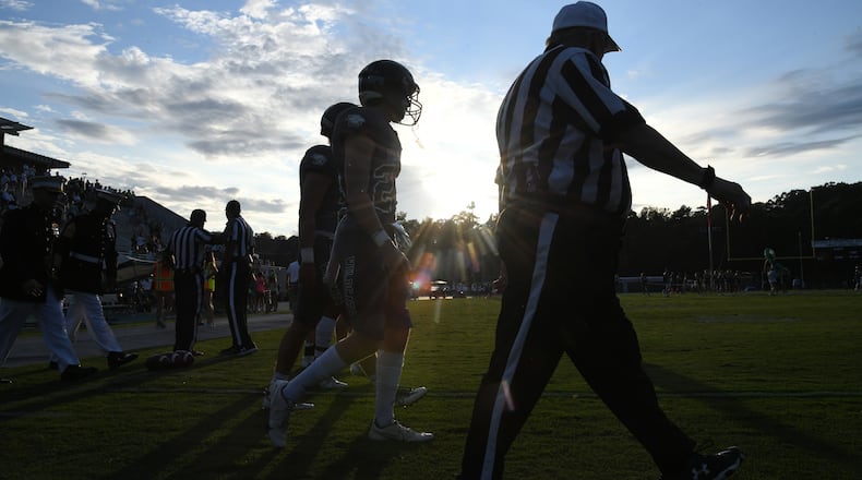 August 20, 2021 Atlanta - Westminster players and referee walk on the field before their season opener game against Lovett at The Westminster Schools in Atlanta on Friday, August 20, 2021. (Hyosub Shin / Hyosub.Shin@ajc.com)