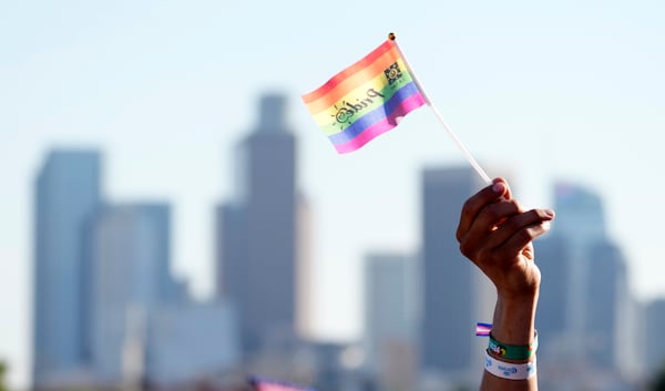 A pride flag is waved against the downtown Los Angeles skyline during the LA Pride in the Park festival at Los Angeles State Historic Park, June 8, 2024, in Los Angeles. (AP Photo/Chris Pizzello)