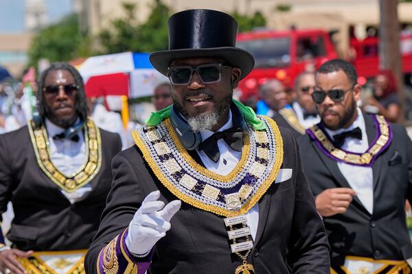 People participate during a Juneteenth parade Thursday, June 19, 2025, in Galveston, Texas. (AP Photo/David J. Phillip)