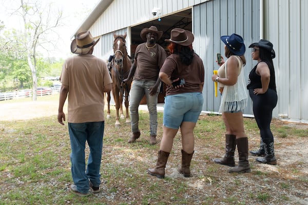 City Mungin, who owns The Outpost West in Winston, talks with attendees of a Cowboys and Creatives event Saturday, April 19, 2025.   Ben Gray for the Atlanta Journal-Constitution