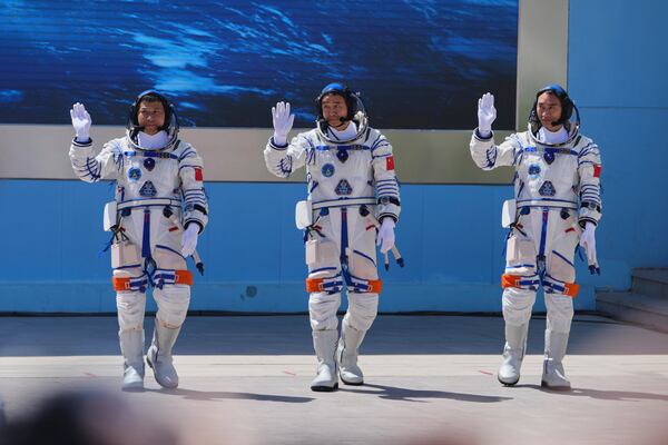 Chinese astronauts for the Shenzhou 20 mission, from right, Chen Zhongrui, Chen Dong and Wang Jie wave as they attend a send-off ceremony for their manned space mission at the Jiuquan Satellite Launch Center in northwestern China, Thursday, April 24, 2025. (AP Photo/Andy Wong)