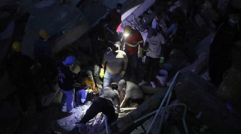 People search through the rubble after an earthquake struck Cali, Colombia, Monday, Aug. 10, 2026. (AP Photo/Santiago Saldarriaga)