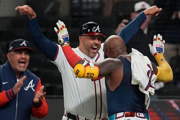Atlanta Braves designated hitter Marcell Ozuna (20) celebrates his walk-off two-run homer against the Philadelphia Phillies in the 11th inning of a baseball game after a rain delay, Friday, April 11, 2025, in Atlanta. (AP Photo/Mike Stewart)