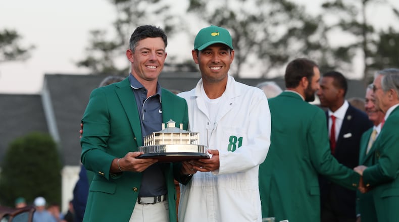 Rory McIlroy celebrates winning the Masters golf tournament with caddie Harry Diamond at Augusta National Golf Club, Sunday, April 13, 2025, in Augusta, Ga. (Jason Getz / AJC)