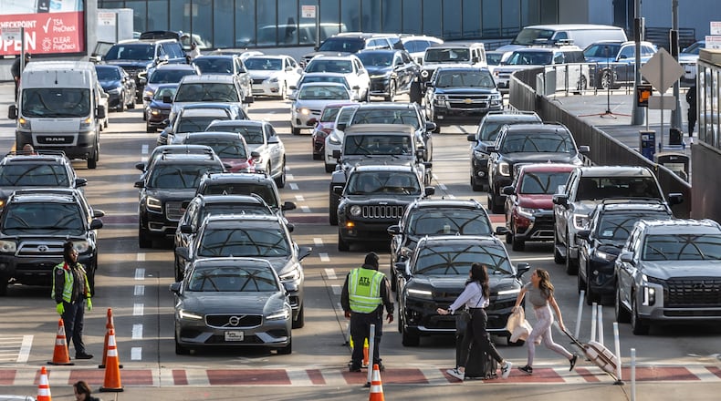 The Thanksgiving air travel period is on as passengers made their way through the airport Friday, Nov. 22, 2024. Traveling through Hartsfield-Jackson International Airport during the holidays can be an ordeal. Parking shortages could disrupt your plans and security waits can be long during busy periods, causing bottlenecks. Hartsfield-Jackson advises travelers to get to the airport at least 2½ hours before their domestic flight and at least 3 hours before their international flight. (John Spink/AJC)