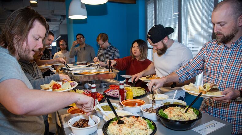 Employees enjoy a catered lunch at SalesLoft in Atlanta on January 23rd, 2019. For AJC Top Workplaces story. (Photo by Phil Skinner)
