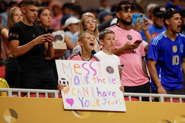Inter Miami fans cheer (and do their best at spelling) ahead of Sunday's Club World Cup match at Mercedes-Benz Stadium.