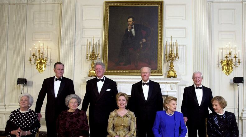 President Clinton, standing, second from left, and first lady Hillary Rodham Clinton, seated, center, pose with Lady Bird Johnson, seated 2nd from left, President Carter and his wife Rosalynn, far right, President Ford and wife Betty, second from right, President Bush and wife Barbara far left, during a dinner in honor of the 200th anniversary of the White House Thursday, Nov. 9, 2000 in Washington. As the nation awaited word on its next chief executive, the three former presidents joined President Clinton at the White House on Thursday night to celebrate the mansion's two centuries as a symbol of leadership and continuity. (AP Photo/Kenneth Lambert)