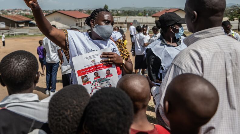 Vanny Birungi, a Red Cross volunteer, speaks to people during a public sensitisation campaign amid the Ebola outbreak in Bunia, Congo, Monday, May 25, 2026. (AP Photo/Moses Sawasawa)