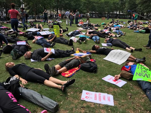 Protesters held a "die-in" at Woodruff Park as President Donald Trump headed Friday to Atlanta to speak to the National Rifle Association annual convention.