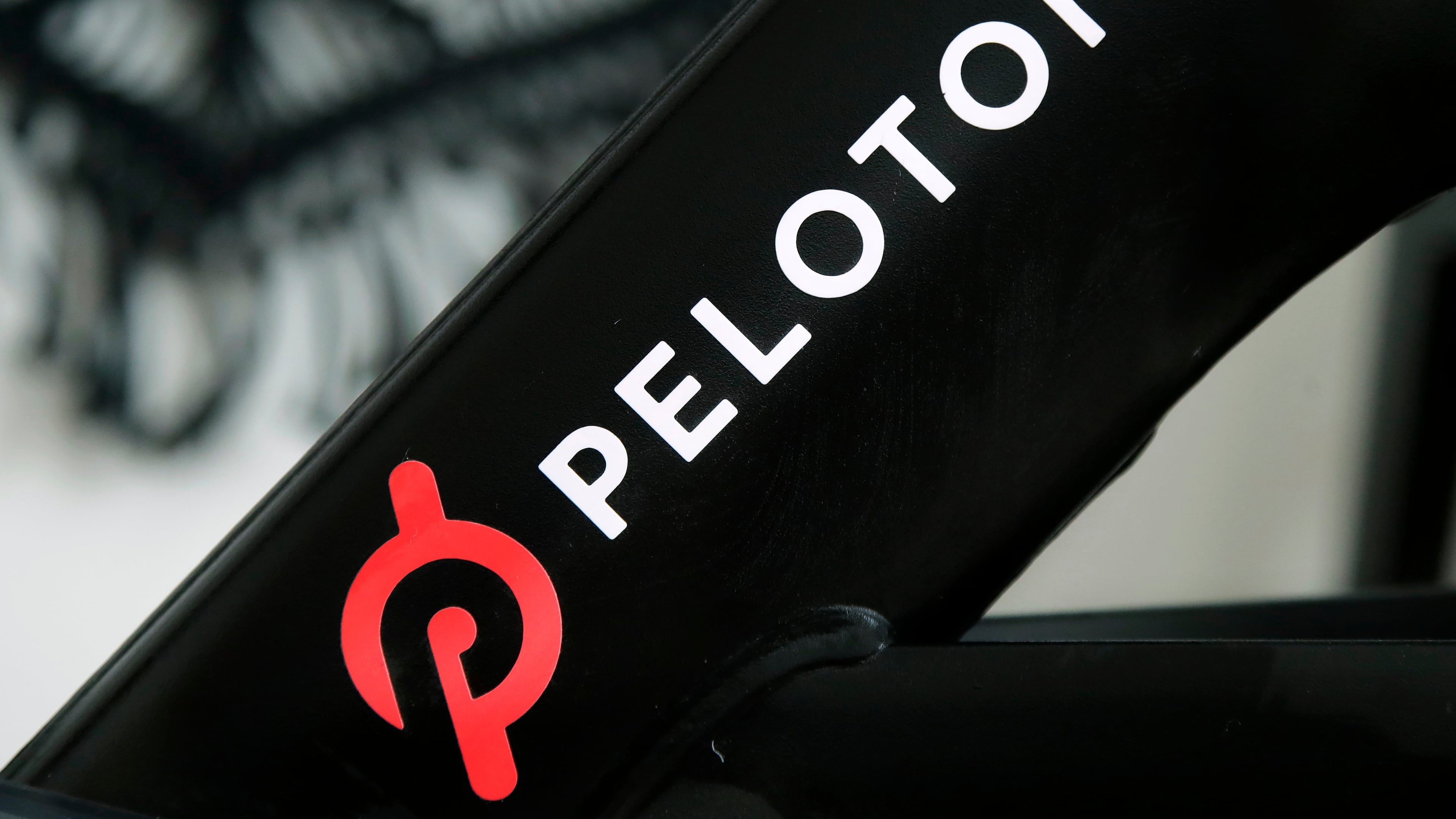 FILE - The Peloton logo is seen on the company's stationary bicycle in San Francisco, Calif., Nov. 19, 2019. (AP Photo/Jeff Chiu, File)