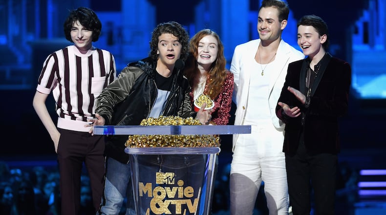 SANTA MONICA, CA - JUNE 16: (L-R) Actors Finn Wolfhard, Gaten Matarazzo, Sadie Sink, Dacre Montgomery, and Noah Schnapp accept the Best Show award for 'Stranger Things' onstage during the 2018 MTV Movie And TV Awards at Barker Hangar on June 16, 2018 in Santa Monica, California. (Photo by Kevin Winter/Getty Images for MTV)