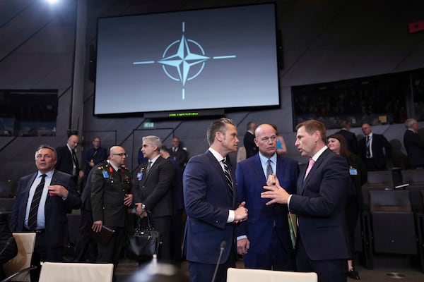 Defense Secretary Pete Hegseth, center, speaks with Estonia's Defense Minister Hanno Pevkur, right, during a meeting of NATO defense ministers at NATO headquarters in Brussels, Thursday, June 5, 2025. (AP Photo/Virginia Mayo)