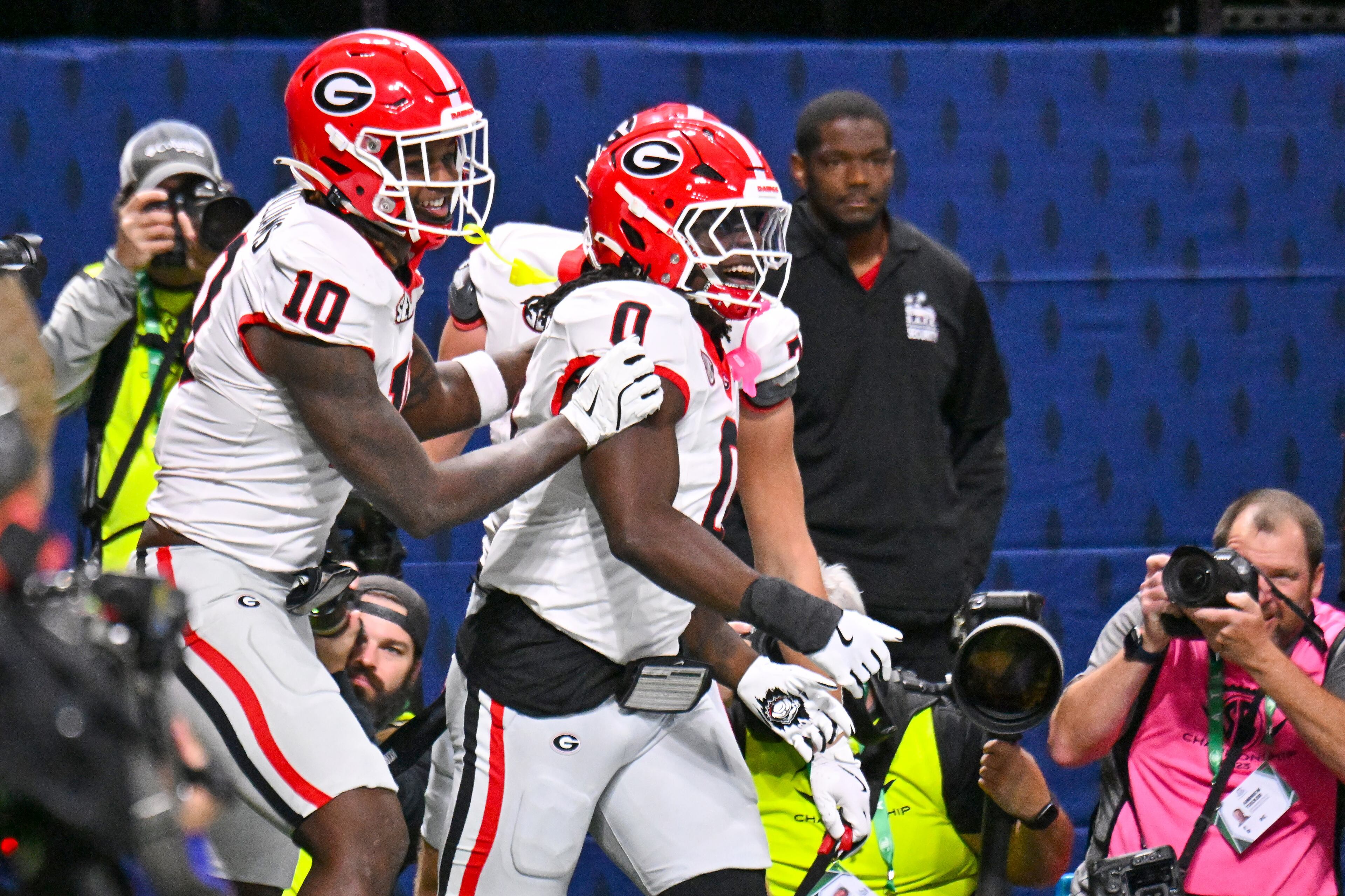 Georgia running back Roderick Robinson II (0) is greeted by tight end Elyiss Williams (10) after scoring the game's first touchdown on a short run past the Alabama defense during the first quarter of the SEC Championship game at Mercedes-Benz Stadium, Saturday, Dec. 6, 2025, in Atlanta. (Hyosub Shin / AJC)