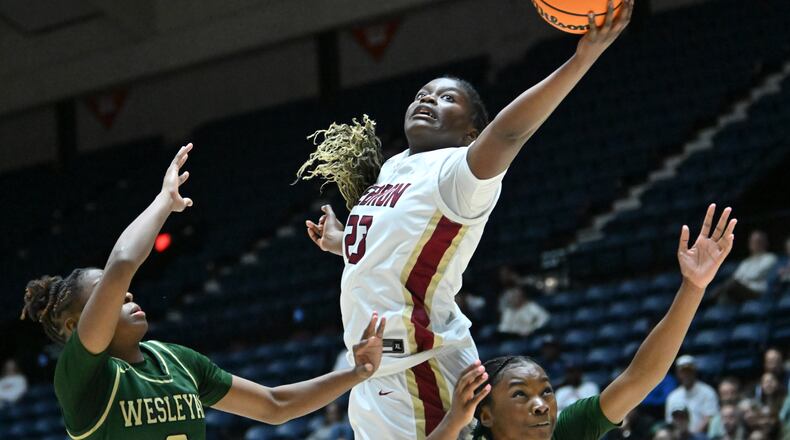 Hebron Christian's Danielle Osho (23) grabs a rebound over Wesleyan's Bryanna Preston (left) and Wesleyan's Chazadi Wright (right) during the first half of GHSA Basketball Class 3A Girl’s State Championship game at the Macon Centreplex, Friday, Mar. 8, 2024, in Macon. (Hyosub Shin / Hyosub.Shin@ajc.com)