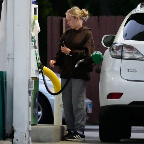 Customer checks gas price before she fills up her vehicle's tank at a gas station in Lincolnshire, Ill., Monday, June 8, 2026. (AP Photo/Nam Y. Huh)