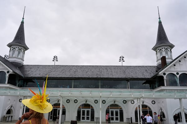 Race fans walk though the grounds at Churchill Downs before the 151st running of the Kentucky Derby horse race Saturday, May 3, 2025, in Louisville, Ky. (AP Photo/Brynn Anderson)