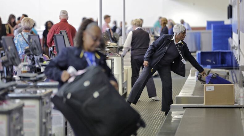 Southwest agents handle baggage from travelers who used the self-tag kiosks. The airline says people can still get help from agents if they need it, but airlines are moving closer to the day when you might be able to make it all the way through the airport from curb to airplane seat barely speaking to a single person. BOB ANDRES /BANDRES@AJC.COM