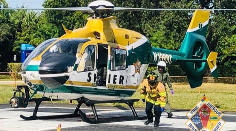 Paramedics prepare to take a construction worker who severed his right arm in an accident to the hospital.