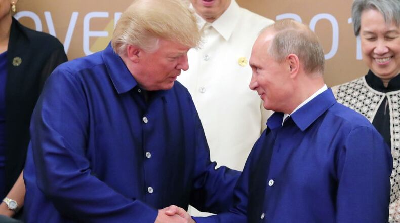 President Donald Trump and Russia's President Vladimir Putin shake hands during a photo ceremony at the 2017 Asia-Pacific Economic Cooperation summit.