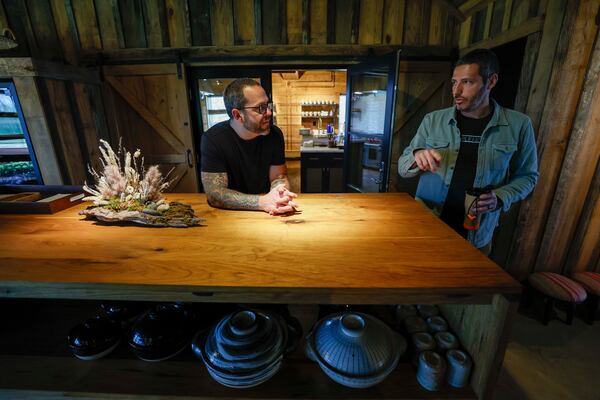 Chef Ryan Smith listens to Angelos Pervanas at Uberto restaurant on Thursday, March 12, 2026. On Friday and Saturday nights, Smith and his team serve seasonal tasting menus at the intimate World of Quercus guest ranch in Meriwether County. (Miguel Martinez/AJC)