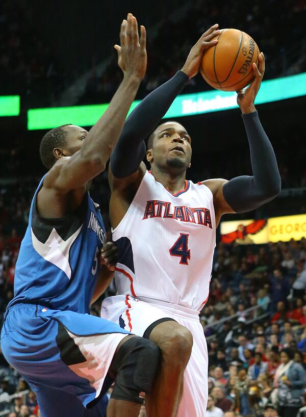 012515 ATLANTA: Hawks Paul Millsap gets past Timberwolves Gorgui Dieng for two of his team high 20-points during a basketball game on Sunday, Jan. 25, 2015, in Atlanta. Curtis Compton / ccompton@ajc.com