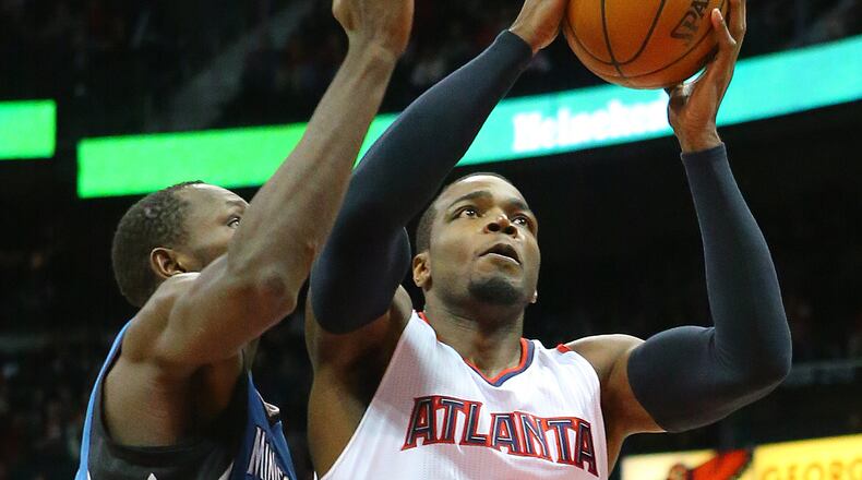 012515 ATLANTA: Hawks Paul Millsap gets past Timberwolves Gorgui Dieng for two of his team high 20-points during a basketball game on Sunday, Jan. 25, 2015, in Atlanta. Curtis Compton / ccompton@ajc.com