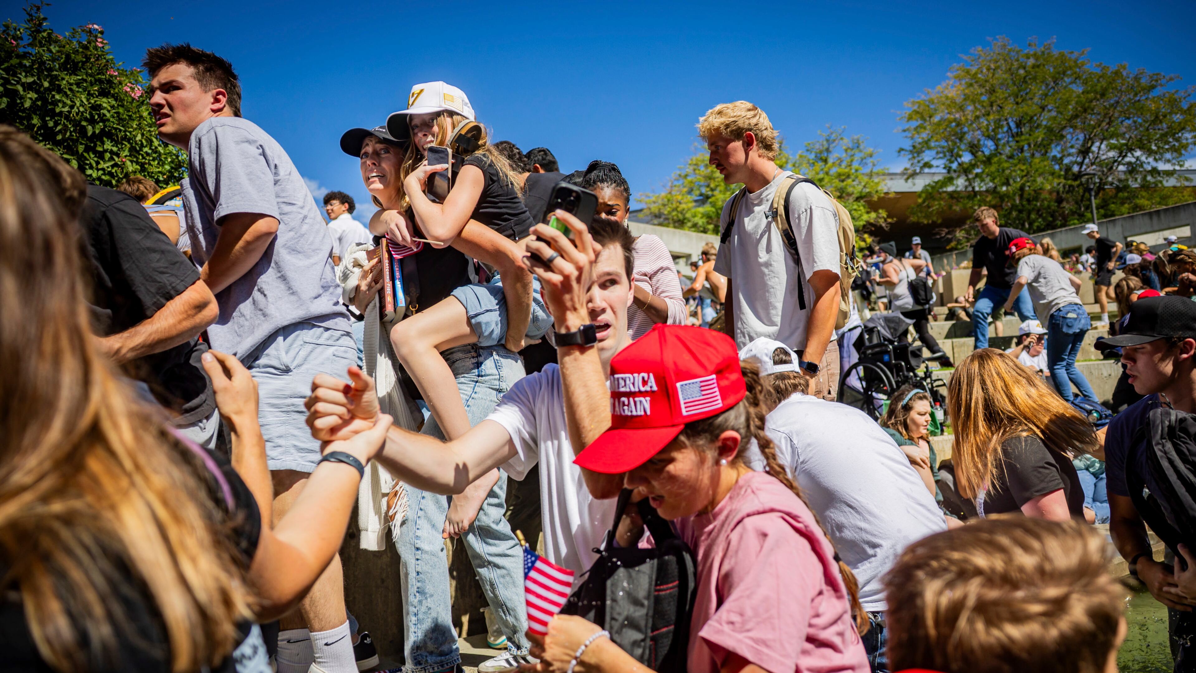 The crowd reacts after Charlie Kirk, the CEO and co-founder of the conservative youth organization Turning Point USA, is shot at the Utah Valley University Wednesday, Sept. 10, 2025, in Orem, Utah. (Tess Crowley/The Deseret News via AP)