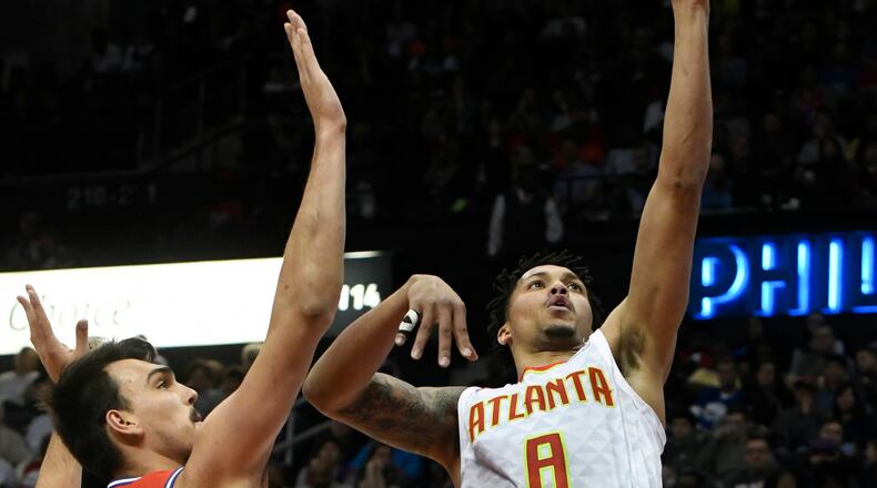 Atlanta Hawks guard Damion Lee, right, shoots as Philadelphia 76ers forward Dario Saric, left, defends during the first half of an NBA basketball game Friday, March 30, 2018, in Atlanta. (AP Photo/John Amis)