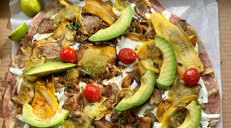 Gato chef Nicholas Stinson’s vegetarian tlayuda comes with mushrooms, summer squash, avocado, cherry tomatoes, bean puree, Oaxacan string cheese and salsa amarillo verde, all on a crispy red tortilla. Wendell Brock for The Atlanta Journal-Constitution