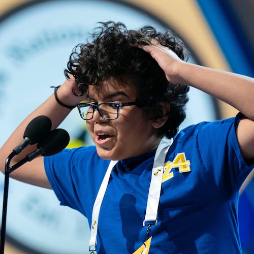 Thivaan Butani, 12, of Austin, Texas reacts after spelling correctly his word during the semifinals of the Scripps National Spelling Bee at DAR Constitution Hall, Wednesday, May 27, 2026, in Washington. (AP Photo/Jose Luis Magana)