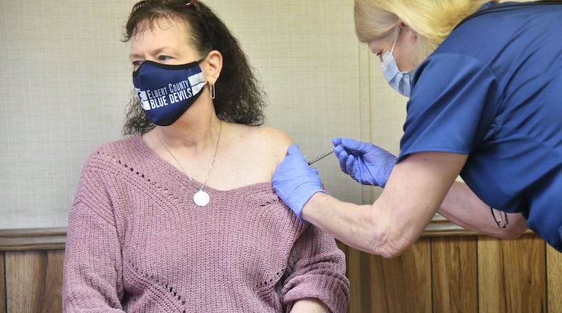 Elbert County High School teacher Tonya Andrews receives her second dose of the COVID-19 vaccine from Tina Mewborne, LPN, at the Medical Center Of Elberton on Wednesday, Jan. 27, 2021. Georgia has not opened COVID-19 vaccination to teachers yet, but a small school district east of Athens still managed to offer shots to any employee who wanted them. Elbert County Superintendent Jon Jarvis told The Atlanta Journal-Constitution that he sees his teachers, bus drivers and other employees as “essential” personnel who should be prioritized for vaccination. (Hyosub Shin / Hyosub.Shin@ajc.com)