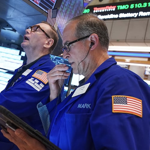 Specialist Patrick King, left, and trader Mark Puetzer work on the floor of the New York Stock Exchange, Friday, June 26, 2026. (AP Photo/Richard Drew)