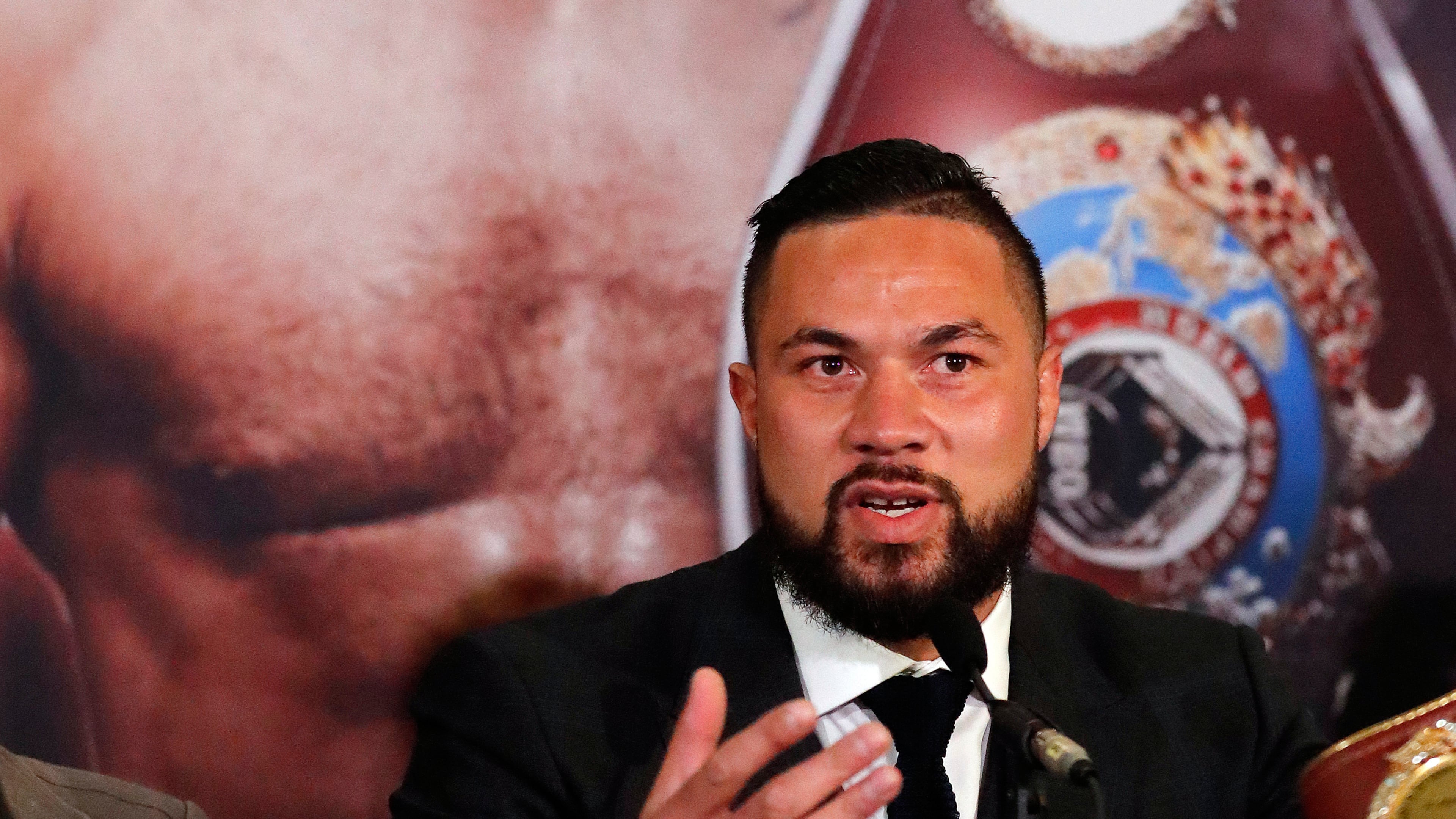 FILE - New Zealand's Joseph Parker speaks in front of his picture during a media conference with World Heavyweight boxer Anthony Joshua of Britain in London, Tuesday, Jan. 16, 2018. (AP Photo/Frank Augstein, File)