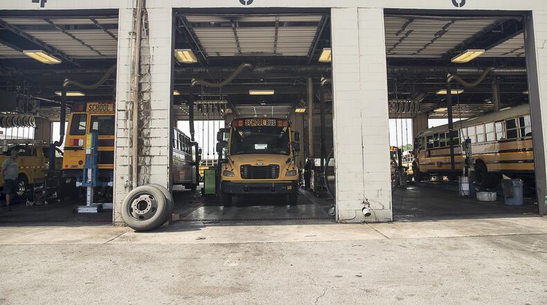 Mechanics work on Atlanta Public School busses at the Atlanta Public Schools Transportation hub in Atlanta’s Sylvan Hills community, Friday, May 31, 2019. (Alyssa Pointer/alyssa.pointer@ajc.com)