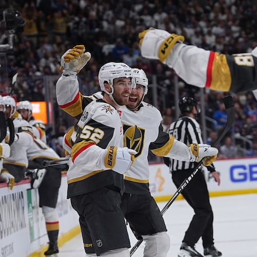 Vegas Golden Knights defenseman Dylan Coghlan, front left, is congratulated after scoring a goal by defenseman Shea Theodore, back left, and center Tomas Hertl during the second period in Game 1 of the Western Conference finals NHL hockey Stanley Cup playoff series against the Colorado Avalanche Wednesday, May 20, 2026, in Denver. (AP Photo/David Zalubowski)