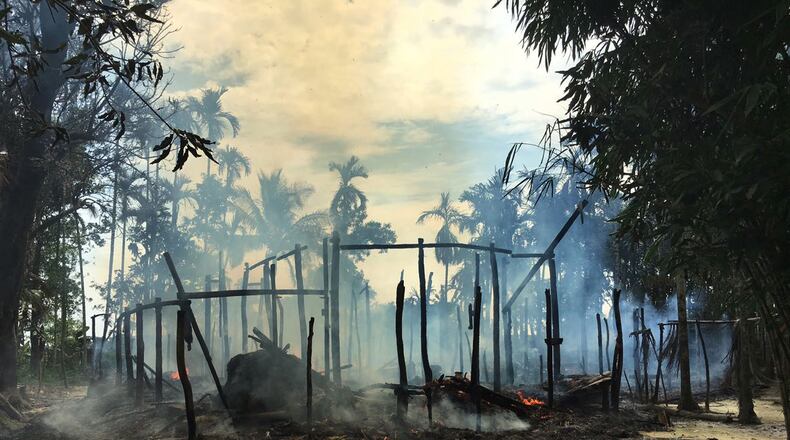FILE - In this Sept. 7, 2017, file photo, smoke rises from a burned house in Gawdu Zara village, northern Rakhine state, where the vast majority of the country's 1.1 million Rohingya lived, Myanmar. (AP Photo, File)
