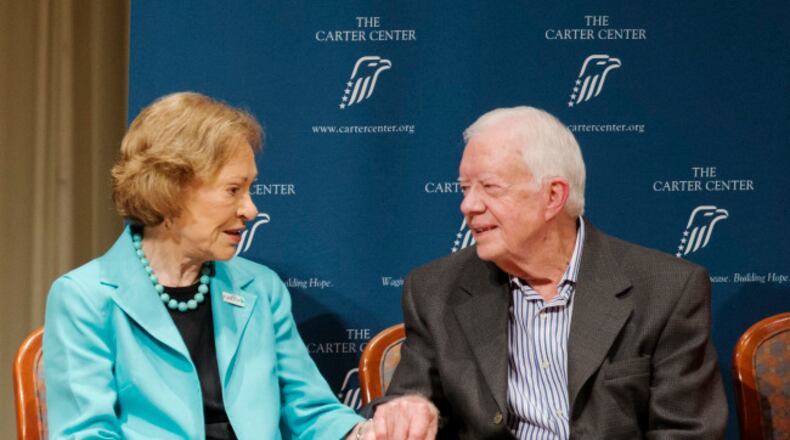Former President Jimmy Carter, right, sits next to wife Rosalynn during his 90th birthday celebration, Wednesday, Oct. 1, 2014, in Atlanta. (AP Photo/David Goldman)