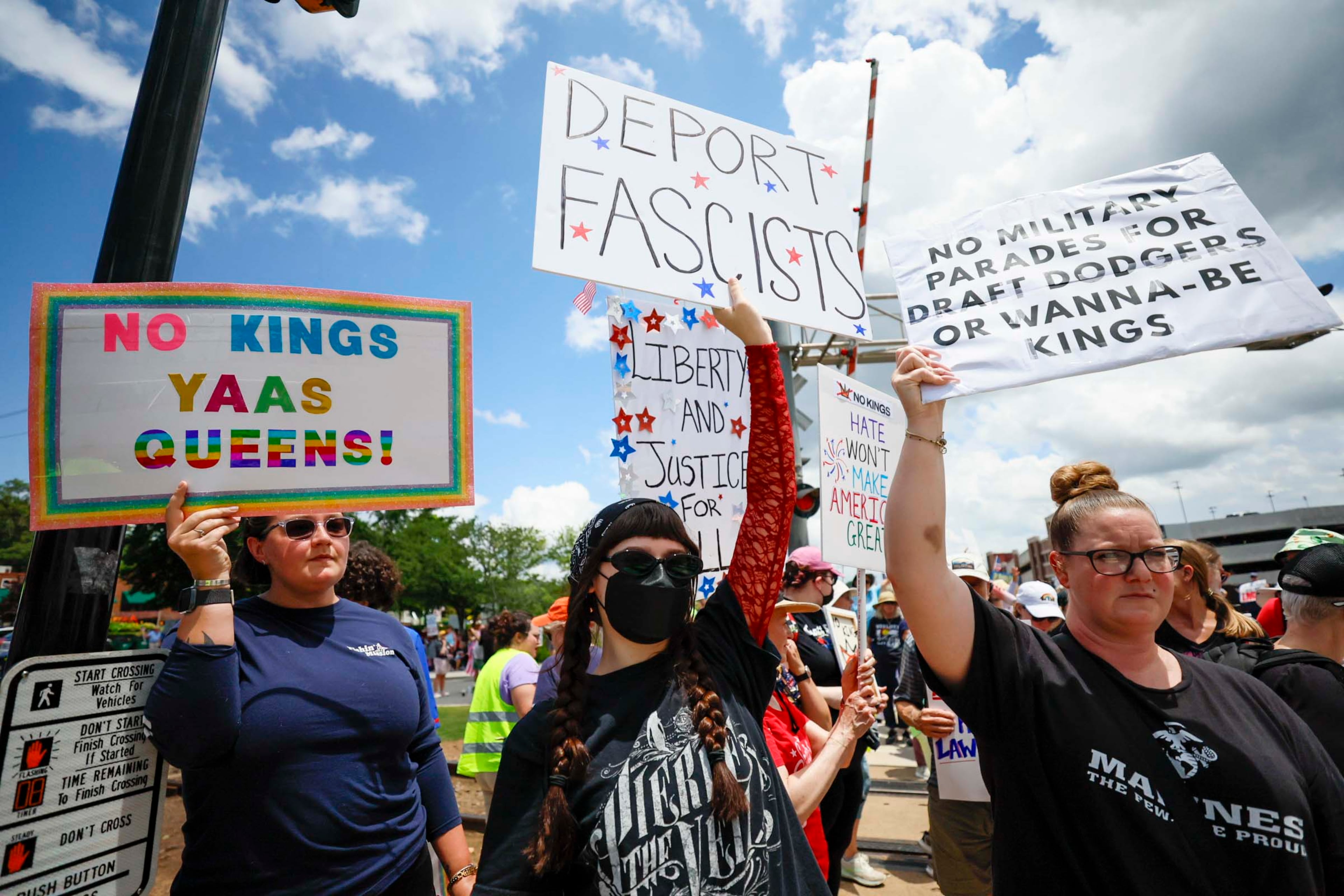 Demonstrators gather in downtown Woodstock to express their opposition to the Trump administration's immigration enforcement policies on Saturday, June 14, 2025.
(Miguel Martinez/ AJC)