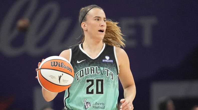 FILE - New York Liberty guard Sabrina Ionescu controls the ball against the Phoenix Mercury during the second half of Game 1 during the first round of the WNBA basketball playoffs Sept. 14, 2025, in Phoenix. (AP Photo/Darryl Webb, File)