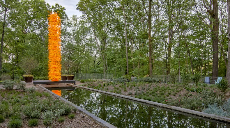 Chihuly's "Saffron Tower" sits in the Storza Woods section of the Atlanta Botanical Gardens. CONTRIBUTED: ATLANTA BOTANICAL GARDEN