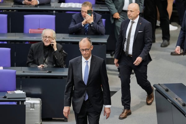 Friedrich Merz walks in the plenary after he was not elected new Chancellor in the first voting process at the parliament Bundestag in Berlin, Tuesday, May 6, 2025. (AP Photo/Markus Schreiber)