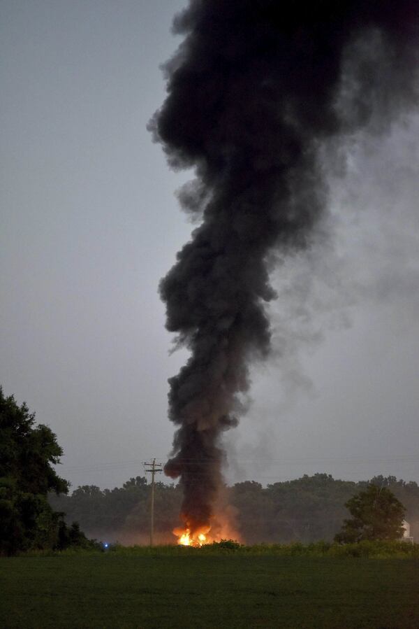 Emergency officials respond to the site of a military plane crash near Itta Bena, Miss., on Monday, July 10, 2017. (Elijah Baylis/The Clarion-Ledger via AP)