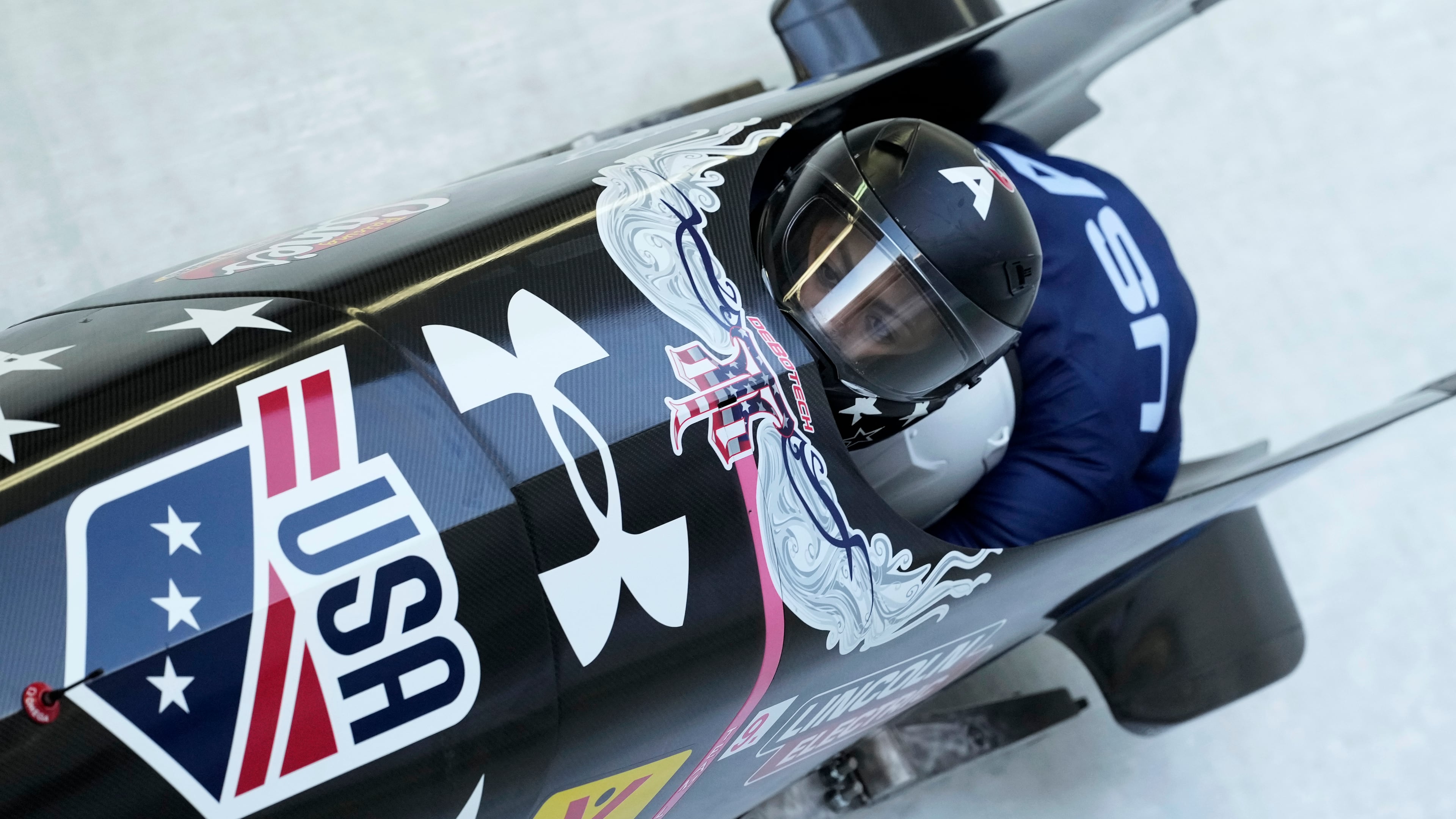 FILE - Kaysha Love and Emily Renna, of the United States, speed down the track during the first run of the 2-woman bobsleigh, at the Bobsleigh World Cup in Innsbruck, Austria, Sunday, Jan. 19, 2025. (AP Photo/Matthias Schrader, File)