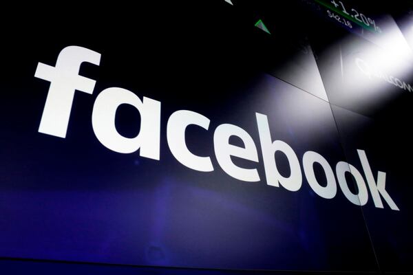 FILE - The logo for Facebook appears on screens in New York's Times Square on March 29, 2018. (AP Photo/Richard Drew, File)