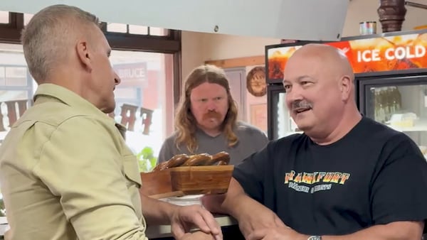 Brian Unger (left) interviews Dean Corbett, chief marketing officer of the Frankfurt Doner & Meats restaurant, pitching a "life-changing sandwich" in Ball Ground. (Courtesy CBS News Atlanta)